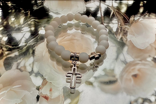 Medium sized beaded bracelet with cross pendant.